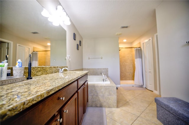 bathroom featuring plus walk in shower, vanity, and tile patterned floors