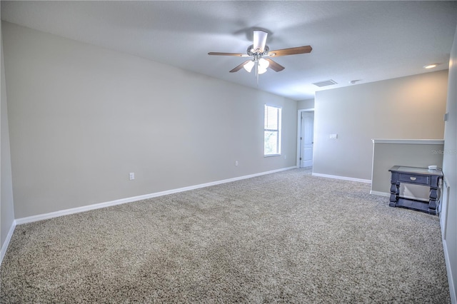 carpeted empty room featuring ceiling fan