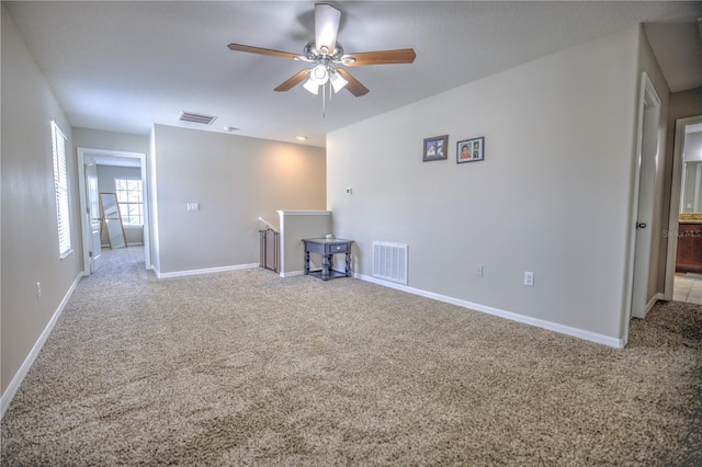 carpeted empty room with ceiling fan