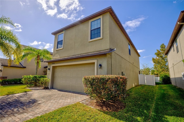 view of front of property with a garage and a front lawn