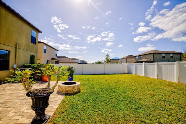 view of yard featuring an outdoor fire pit and a patio area