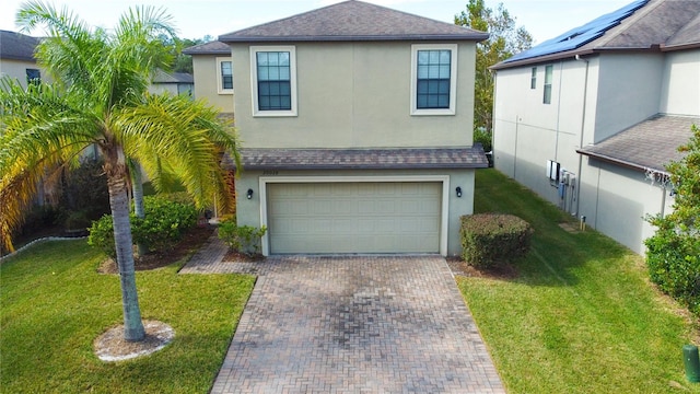 view of front of property with a garage and a front yard