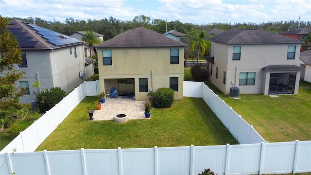 exterior space featuring a front lawn, central air condition unit, and a patio