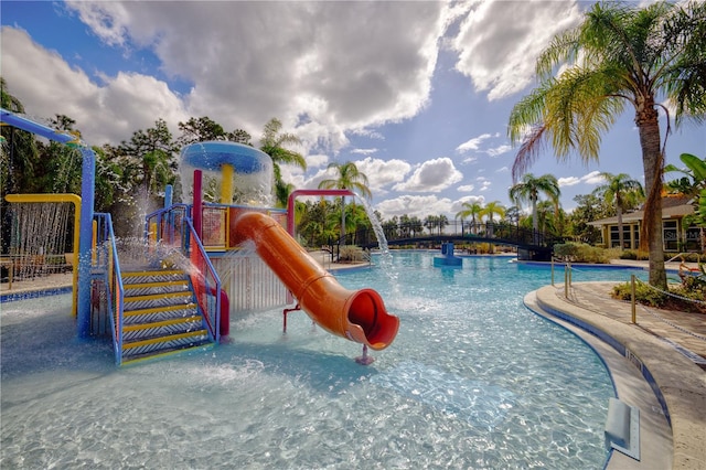 view of jungle gym with pool water feature and a community pool