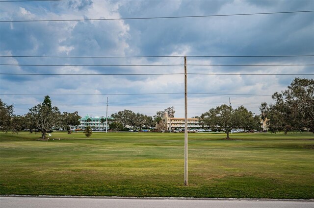 view of property's community with a lawn