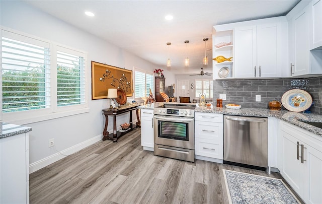 kitchen featuring white cabinetry, stainless steel appliances, a wealth of natural light, and light hardwood / wood-style flooring