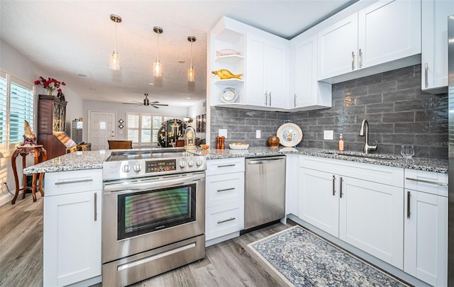 kitchen with kitchen peninsula, white cabinetry, ceiling fan, and appliances with stainless steel finishes