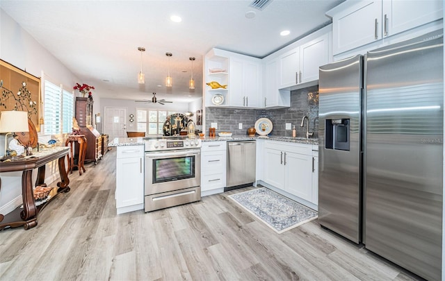 kitchen with ceiling fan, white cabinetry, kitchen peninsula, and appliances with stainless steel finishes