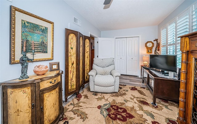 sitting room featuring ceiling fan and light hardwood / wood-style floors