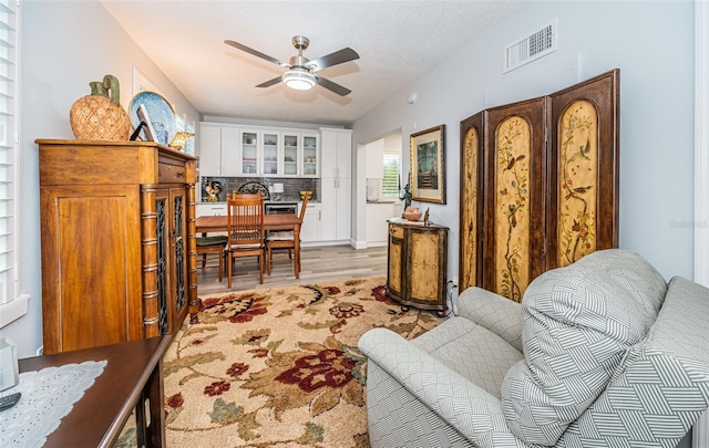 office space featuring ceiling fan and light hardwood / wood-style floors