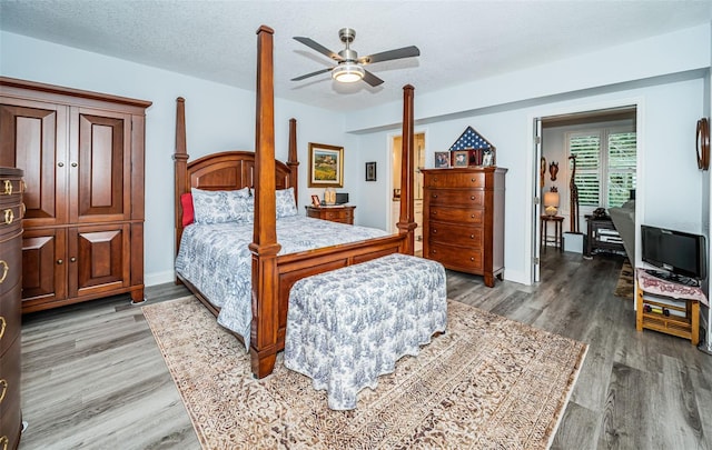 bedroom with wood-type flooring, a textured ceiling, and ceiling fan