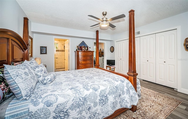 bedroom featuring ceiling fan, dark hardwood / wood-style floors, a textured ceiling, and two closets