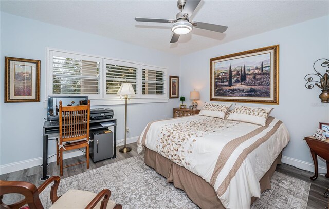 bedroom with ceiling fan and wood-type flooring