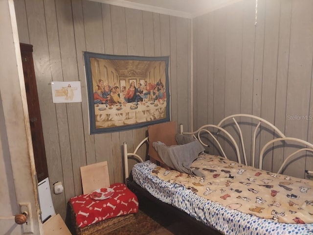 bedroom featuring wooden walls