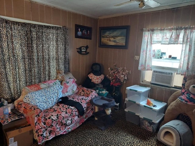 bedroom with cooling unit, wood walls, ceiling fan, and crown molding