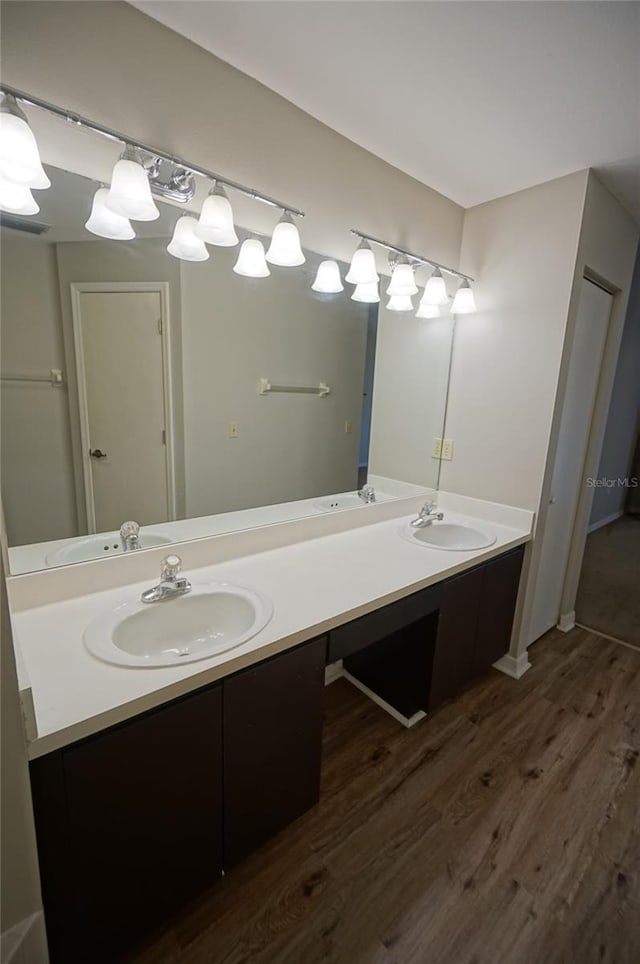 bathroom with hardwood / wood-style floors and vanity