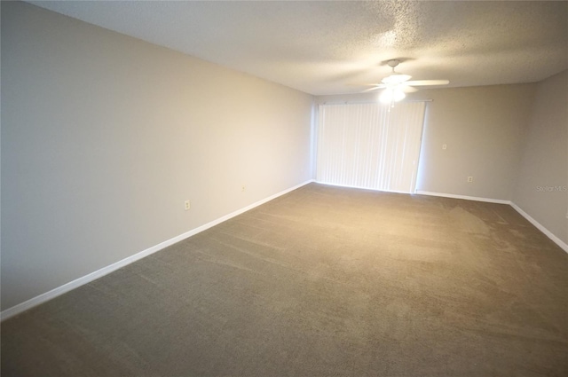 carpeted spare room with ceiling fan and a textured ceiling