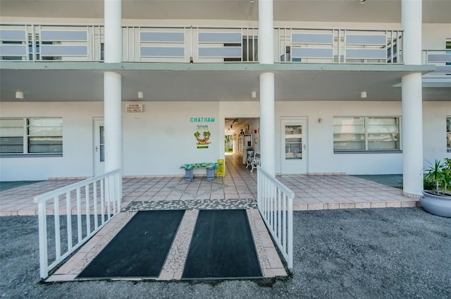 entrance to property featuring stucco siding