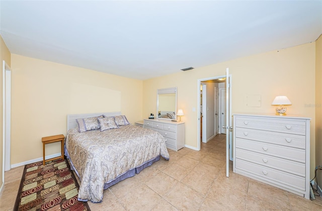 bedroom featuring light tile patterned floors, visible vents, and baseboards