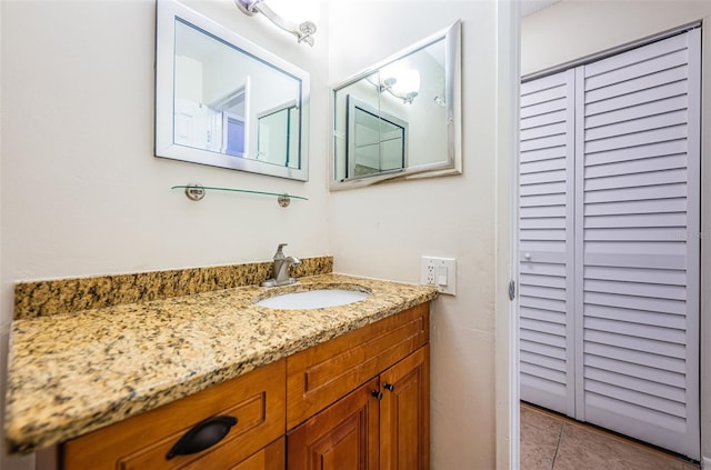 bathroom featuring a closet, vanity, and tile patterned floors