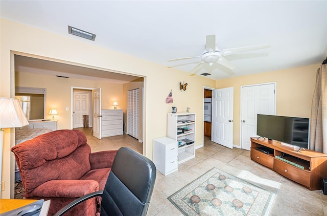 living room with ceiling fan and light tile patterned floors