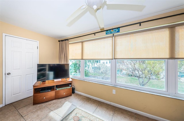 unfurnished living room with tile patterned flooring, ceiling fan, and plenty of natural light