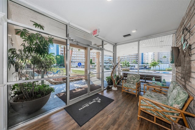 sunroom / solarium featuring a city view and visible vents