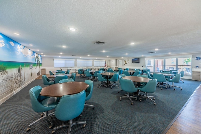 dining area with visible vents, a textured ceiling, and recessed lighting