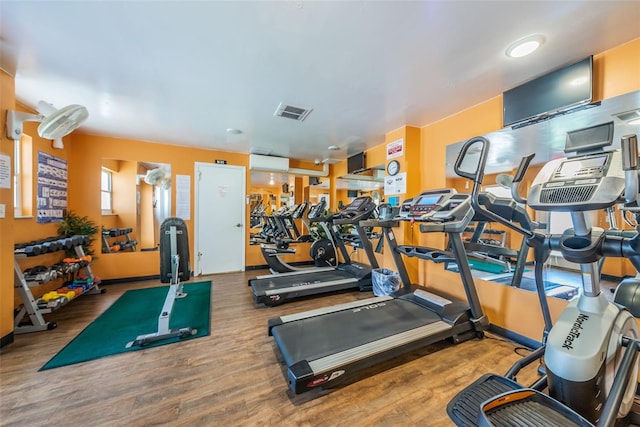 workout area with visible vents and wood finished floors