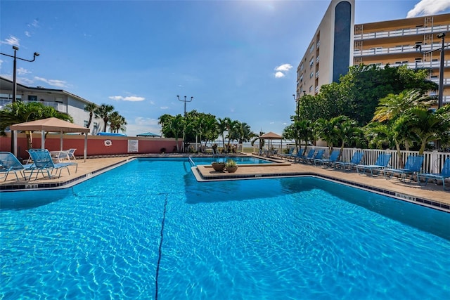 pool featuring a gazebo, a patio, and fence