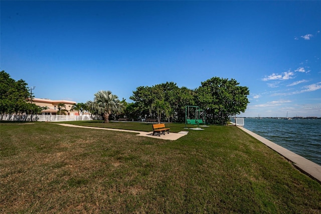 view of yard featuring a water view and fence