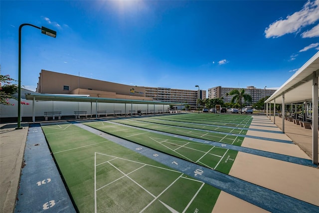 surrounding community featuring shuffleboard and a city view