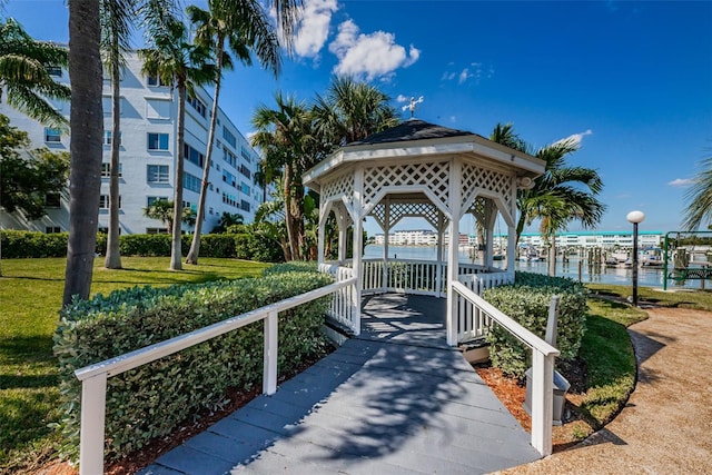 view of property's community with a water view, a yard, and a gazebo