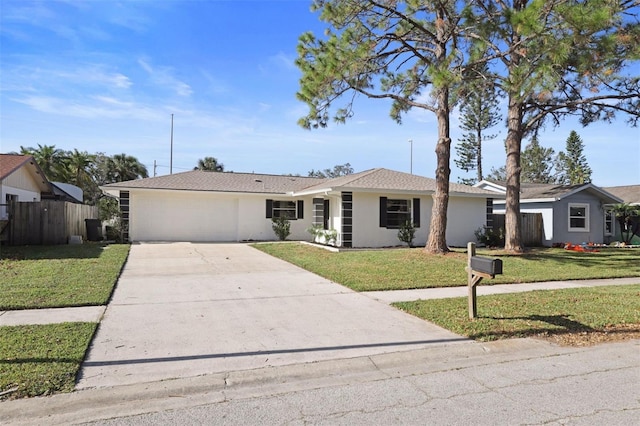 single story home featuring a garage and a front yard