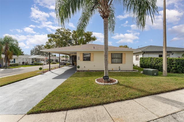 view of front facade with a carport and a front yard