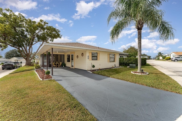 view of front facade with a carport and a front lawn