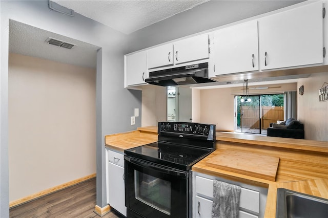 kitchen featuring hardwood / wood-style floors, white cabinetry, a textured ceiling, and black electric range oven