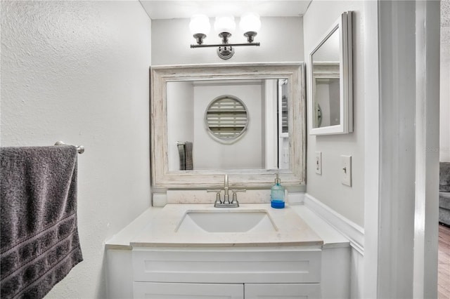 bathroom featuring vanity and hardwood / wood-style floors