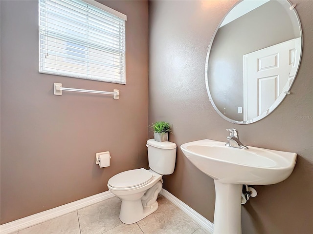 bathroom with tile patterned flooring and toilet