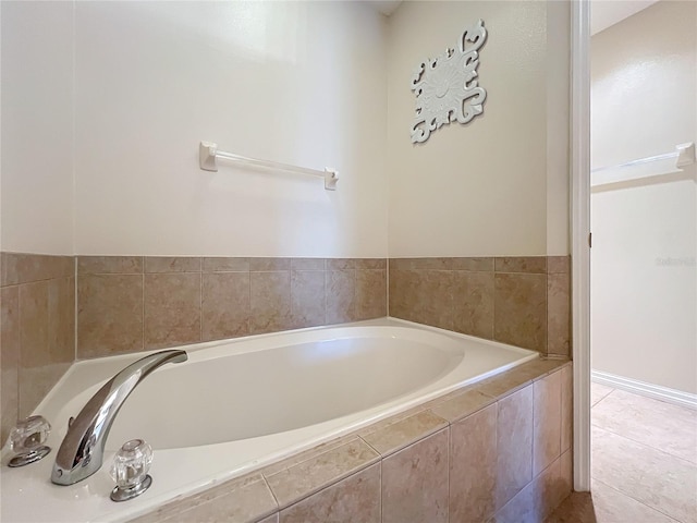 bathroom with tiled bath and tile patterned flooring