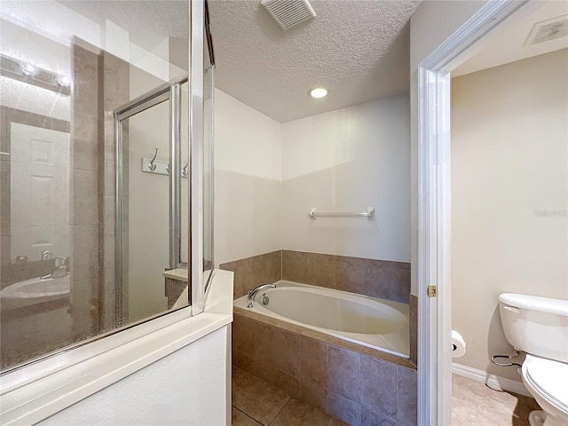 bathroom with tile patterned flooring, a textured ceiling, toilet, and plus walk in shower