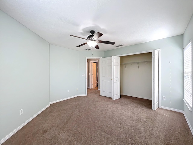 unfurnished bedroom featuring a closet, ceiling fan, and carpet floors