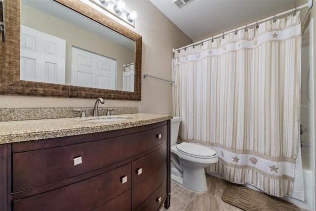 bathroom featuring tile patterned floors, vanity, and toilet