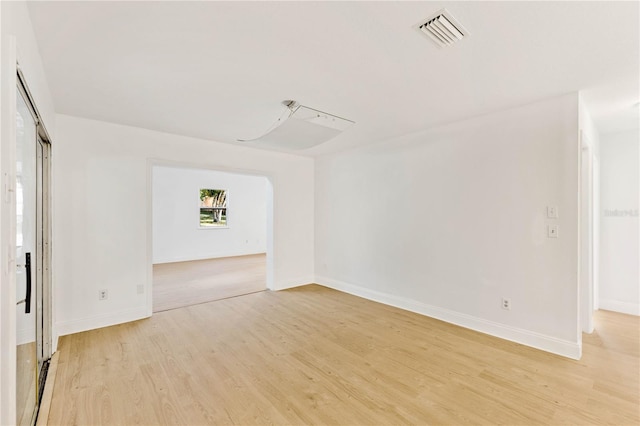 unfurnished room with light wood-type flooring