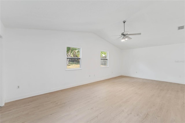 empty room featuring lofted ceiling, ceiling fan, and light hardwood / wood-style flooring