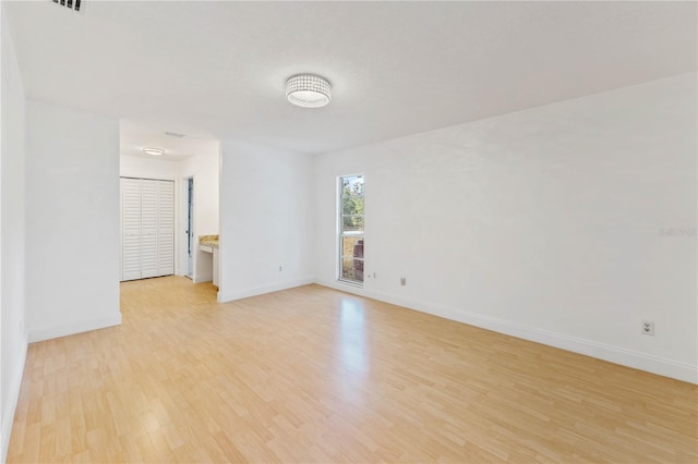 spare room with light hardwood / wood-style flooring