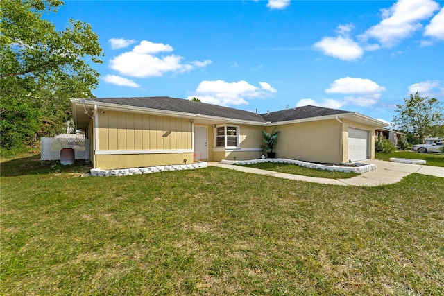 view of front of property with a garage and a front lawn