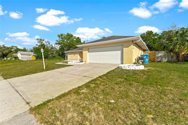 view of front of property featuring a front yard and a garage