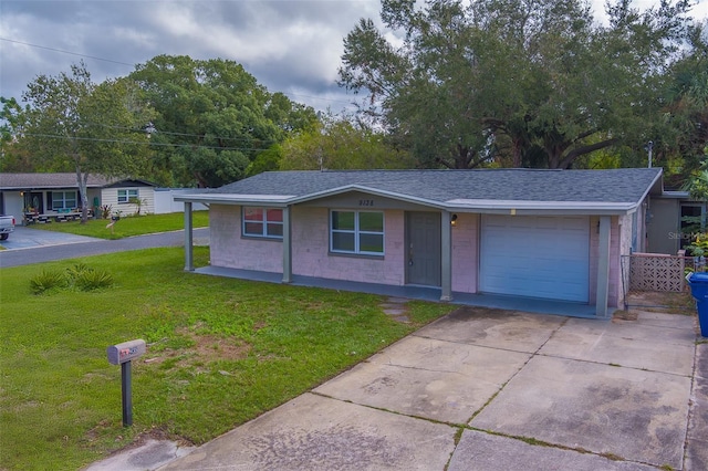 ranch-style home featuring a garage and a front yard