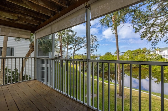 unfurnished sunroom with a water view